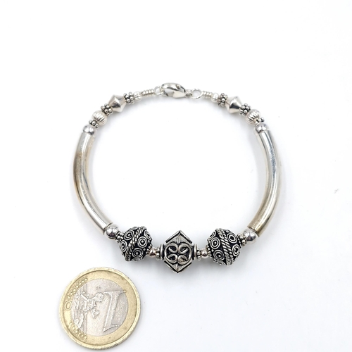 978 - A Sterling Silver Greek Style bracelet. 16g