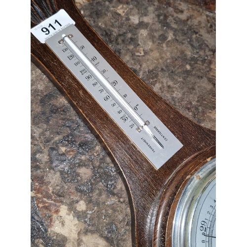 911 - Antique British barometer featuring carved oak design, thermometer, and barometric dial. 