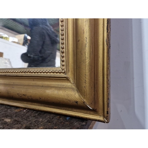 919 - Ormolu gilt mirror with beaded detailing, featuring a classic rectangular design. Approximately 95 c... 