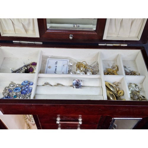 140 - A splendid wooden jewelry box featuring two glass fronted compartments to each side for storing neck... 