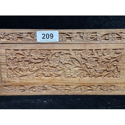 209 - An excellent hand carved olive wood extendable book slide boasting pierced foliate detail.