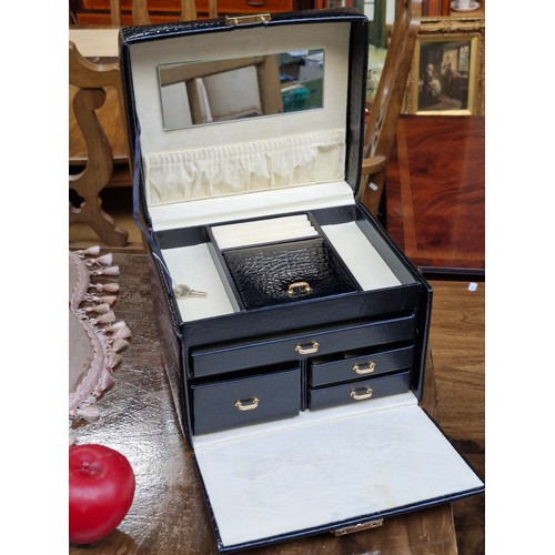 389 - A quality patent leather bound travel jewellery case box. With brass hardware and original key. Simi... 