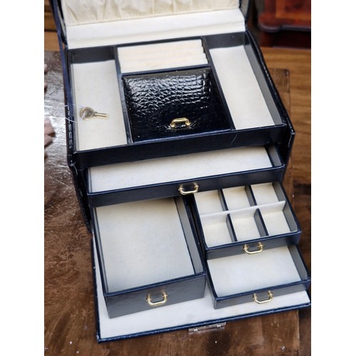 389 - A quality patent leather bound travel jewellery case box. With brass hardware and original key. Simi... 