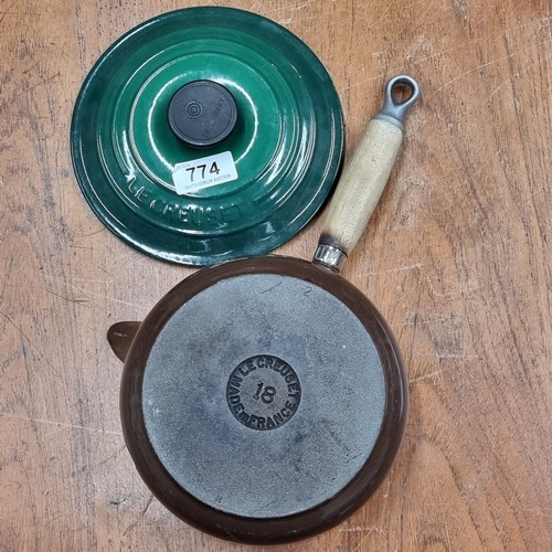 774 - A Le Creuset lidded saucepan with wooden handle. In very good condition.