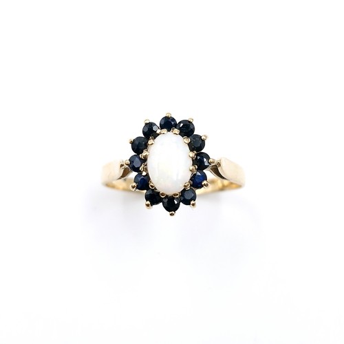 2 - Star Lot : A pretty nine carat gold opal stone ring with sapphire stone surround. Ring size - M 1/2.... 