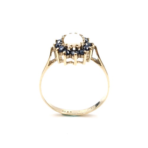 2 - Star Lot : A pretty nine carat gold opal stone ring with sapphire stone surround. Ring size - M 1/2.... 