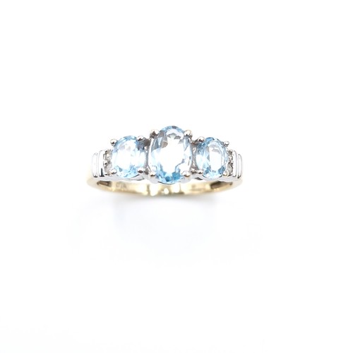 3 - Star lot : A stunning nine carat gold three stone topaz ring set with diamonds. Size - O. Weight - 2... 