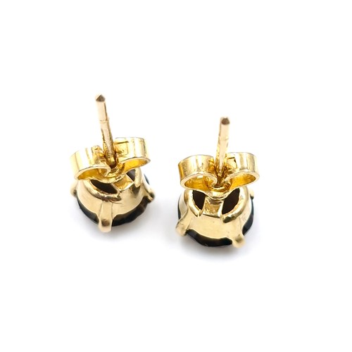 4 - A pair of nine carat gold smoky quartz stud earrings. Weight - 1.78 grams.