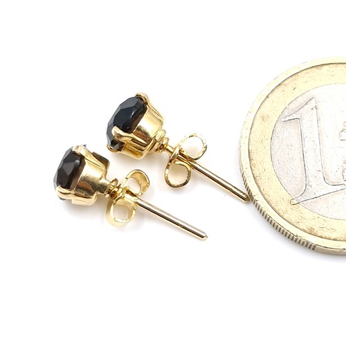 4 - A pair of nine carat gold smoky quartz stud earrings. Weight - 1.78 grams.