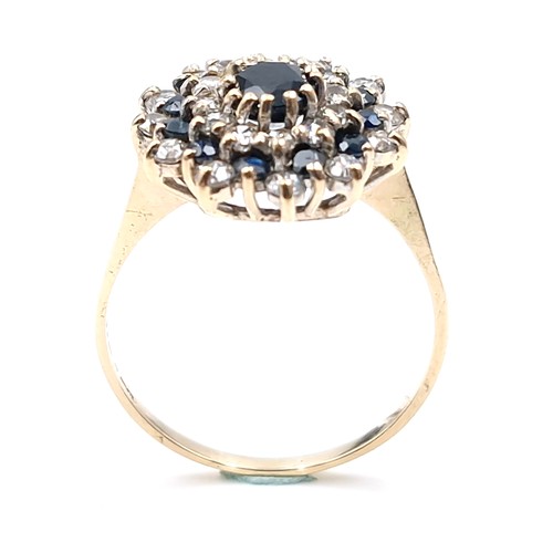 7 - Star Lot : A large vintage sapphire and diamond cluster ring set in nine carat gold. Size - V. Weigh... 