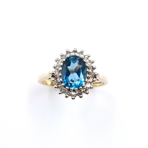 8 - Star Lot : A fine example of a large blue topaz stone ring set with diamond surround mounted in nine... 