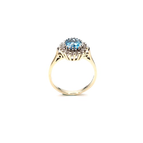 8 - Star Lot : A fine example of a large blue topaz stone ring set with diamond surround mounted in nine... 