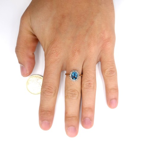 8 - Star Lot : A fine example of a large blue topaz stone ring set with diamond surround mounted in nine... 