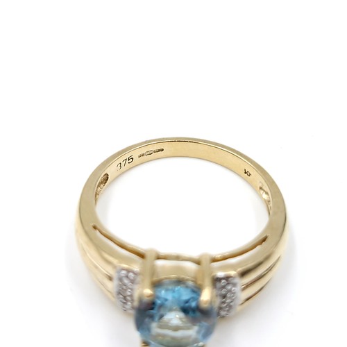 12 - Star Lot : A fabulous large blue topaz and diamond ring set in nine carat gold. Ring size - L 1/2. W... 