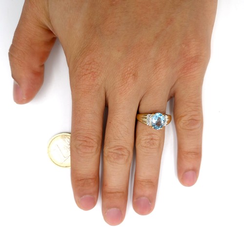 12 - Star Lot : A fabulous large blue topaz and diamond ring set in nine carat gold. Ring size - L 1/2. W... 