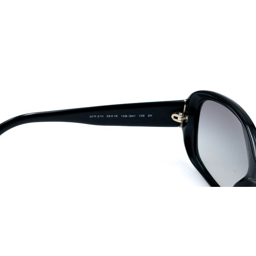 21 - A pair of original designer Prada sunglasses 'Made in Italy' with serial marks to frame. Lenses in g... 