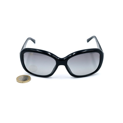 21 - A pair of original designer Prada sunglasses 'Made in Italy' with serial marks to frame. Lenses in g... 