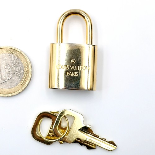 38 - An original  Louis Vuitton pad lock. Weight - 31.52 grams.