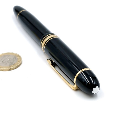 56 - Star Lot : A Mont Blanc fountain pen with a 14 carat (585) nib set with gold toned detailing.