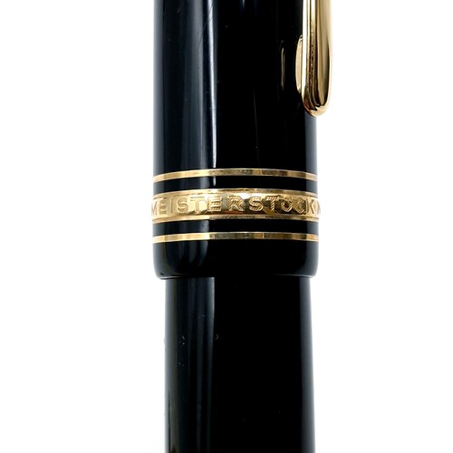 56 - Star Lot : A Mont Blanc fountain pen with a 14 carat (585) nib set with gold toned detailing.