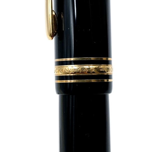 56 - Star Lot : A Mont Blanc fountain pen with a 14 carat (585) nib set with gold toned detailing.