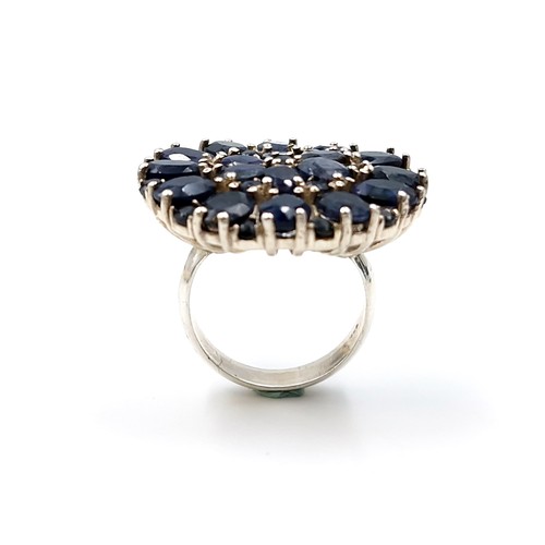 510 - Star Lot : A fabulous large sapphire floral ring. Size - R. Weight - 11.94 grams.  Brand new from th... 