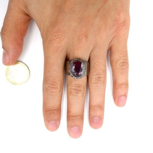 513 - Star Lot : A fine example of a wide band facet cut natural ruby and diamond Ring mounted in sterling... 