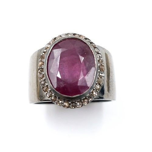 513 - Star Lot : A fine example of a wide band facet cut natural ruby and diamond Ring mounted in sterling... 