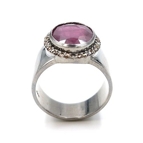 513 - Star Lot : A fine example of a wide band facet cut natural ruby and diamond Ring mounted in sterling... 