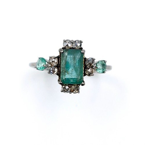 520 - Star Lot : A very pretty  three emerald and eight diamond ring mounted in sterling silver. Size - P.... 