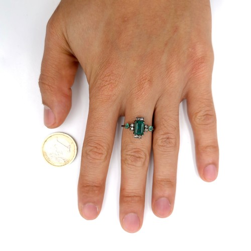 520 - Star Lot : A very pretty  three emerald and eight diamond ring mounted in sterling silver. Size - P.... 