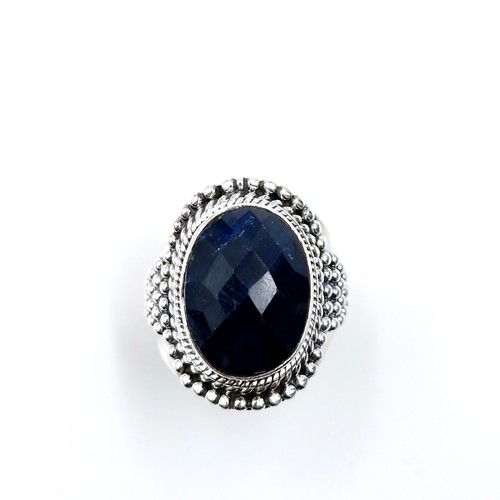 521 - A large cabachon sapphire stone set ring with dimple machine cut detailing set in sterling silver. S... 