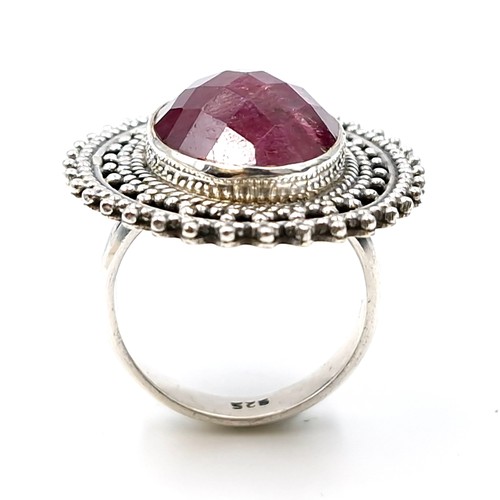 522 - An unusual ruby gemstone ring with inlaid machine cut detailing. Size - O. Weight - 11.42 grams.  Br... 