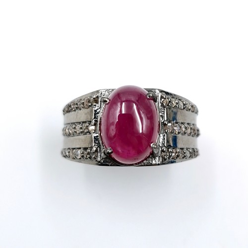 530 - Star lot : A cabochon ruby stone ring with a three strand diamond mount set in sterling silver. Ring... 