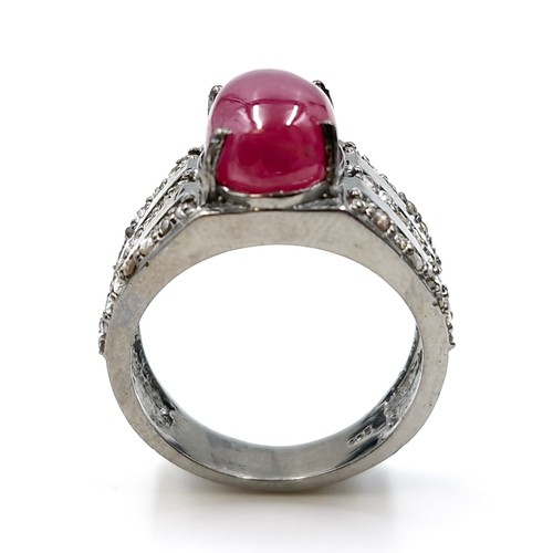 530 - Star lot : A cabochon ruby stone ring with a three strand diamond mount set in sterling silver. Ring... 