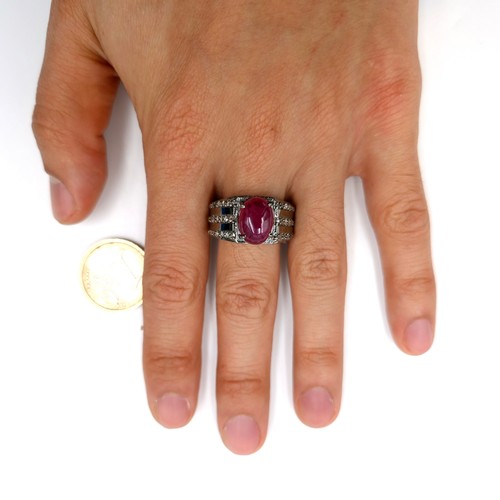 530 - Star lot : A cabochon ruby stone ring with a three strand diamond mount set in sterling silver. Ring... 