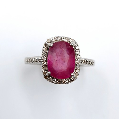 531 - Star lot : A pretty cabochon ruby gemstone ring set with diamond surround mounted in sterling silver... 