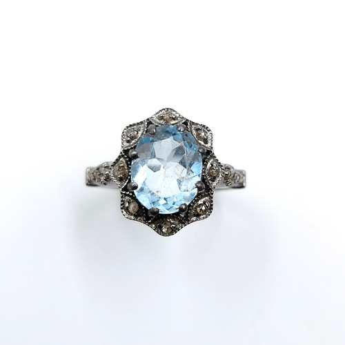 536 - Star Lot : A three carat blue topaz ring with 0.25 carat diamond accents set in sterling silver. Rin... 