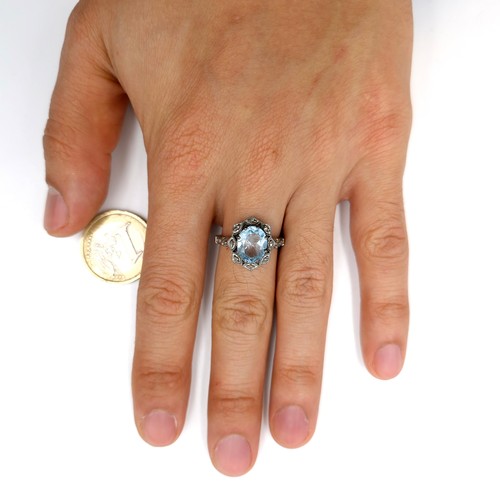 536 - Star Lot : A three carat blue topaz ring with 0.25 carat diamond accents set in sterling silver. Rin... 