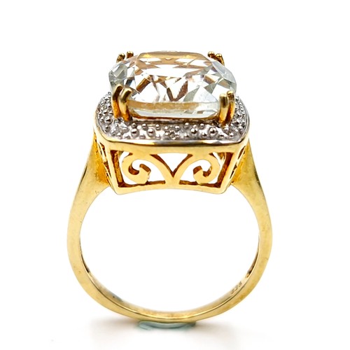 550 - A most attractive gold plated large citrine stone ring with gem set surround and claw mount. Ring si... 