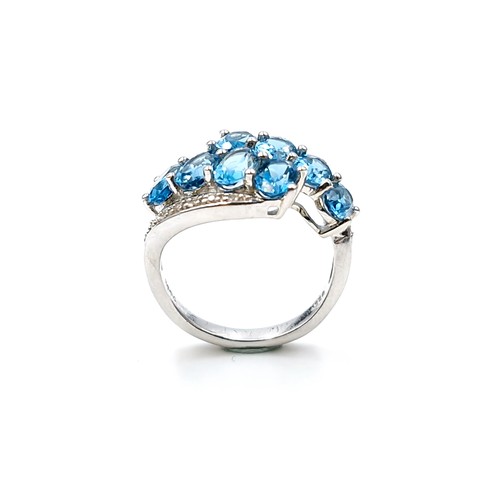 554 - A twin twist eight stone blue topaz ring set in sterling silver with TGGC stamped to band (The Genui... 