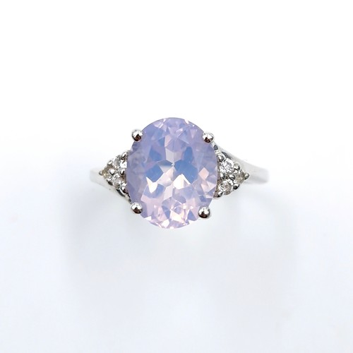 555 - A very attractive lavender quartz gemstone ring set with bright diamond accents to band marked TGGC ... 