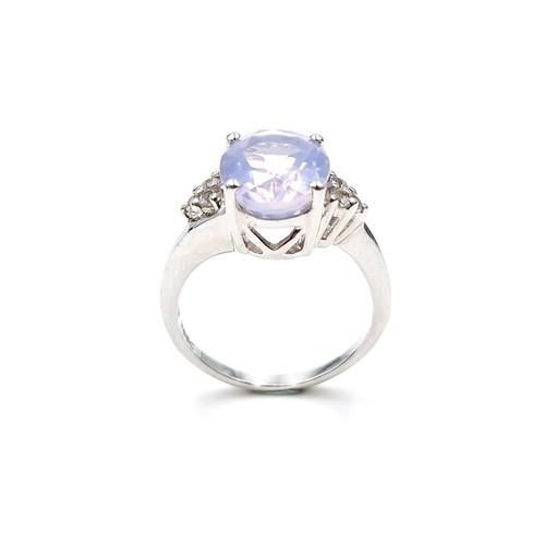 555 - A very attractive lavender quartz gemstone ring set with bright diamond accents to band marked TGGC ... 