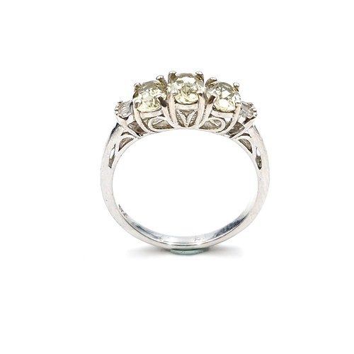 560 - A most attractive three stone peridot ring with diamond accents to shoulders set in sterling silver.... 