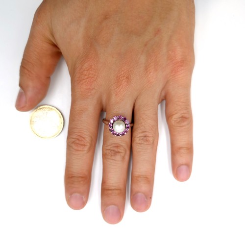 561 - Star Lot : A pretty cabochon pearl and amethyst stone cluster ring with TGGC marked to band (The Gen... 