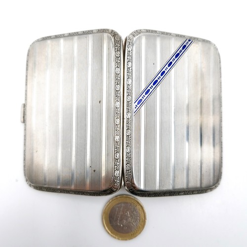 568 - A good quality sterling silver marked 925 cigarette case with blue enamel and machine cut detailing ... 