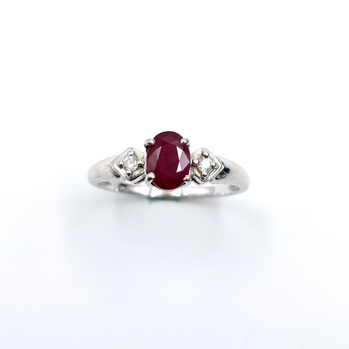 592 - Star lot : A nine carat white gold ruby and diamond ring. Diamond stamped to band. Ring size - P. We... 