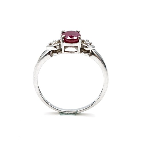 592 - Star lot : A nine carat white gold ruby and diamond ring. Diamond stamped to band. Ring size - P. We... 