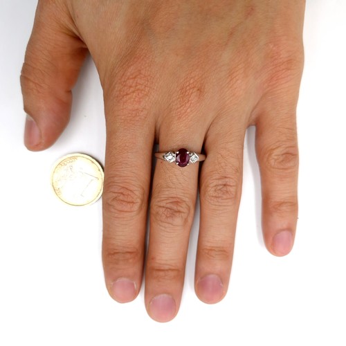 592 - Star lot : A nine carat white gold ruby and diamond ring. Diamond stamped to band. Ring size - P. We... 