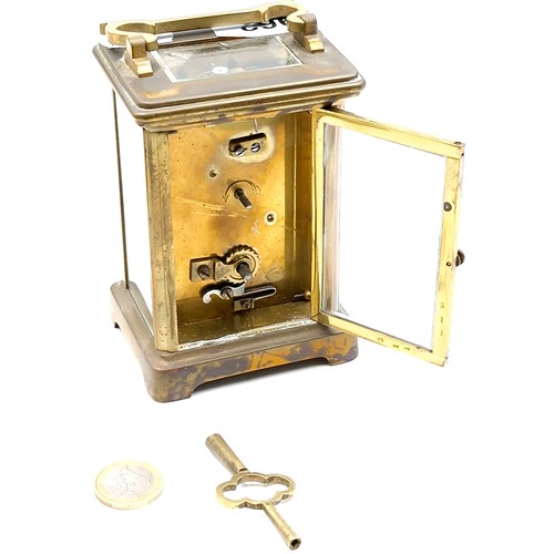 962 - An antique mechanical carriage clock, good example with glass sides and top and original key.